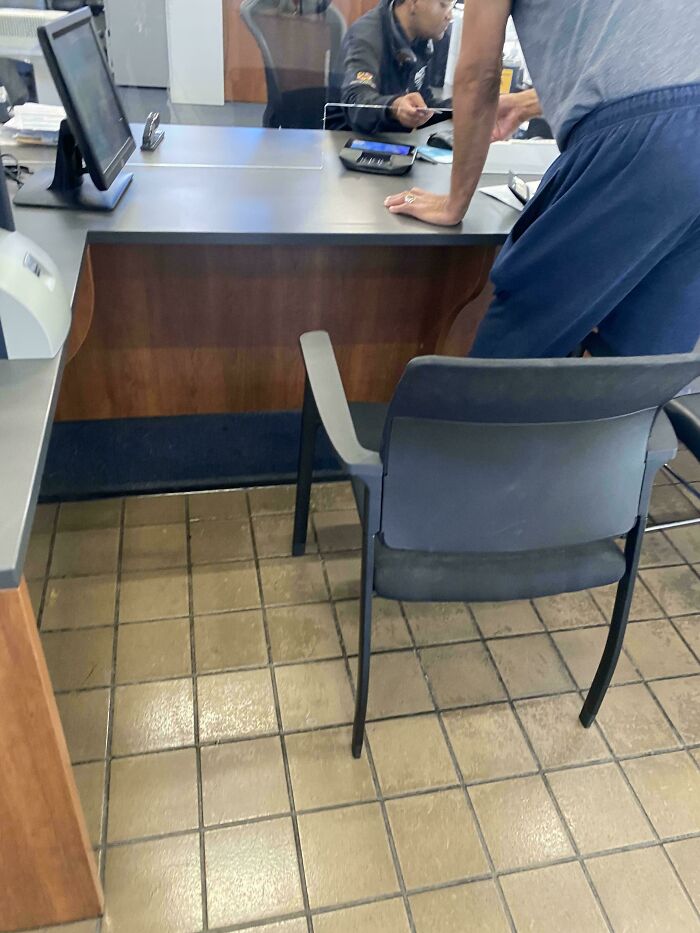 A man leaning on a counter at an office, reflecting on the little hope for humanity.