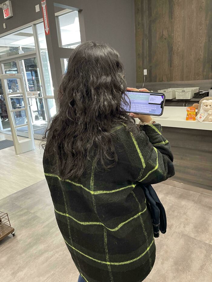 A person holding their phone horizontally to record, illustrating little hope for humanity.
