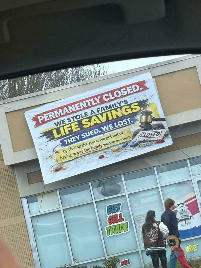 A large banner on a closed store reads, We Stole a Family's Life Savings, depicting a reason for little hope for humanity.