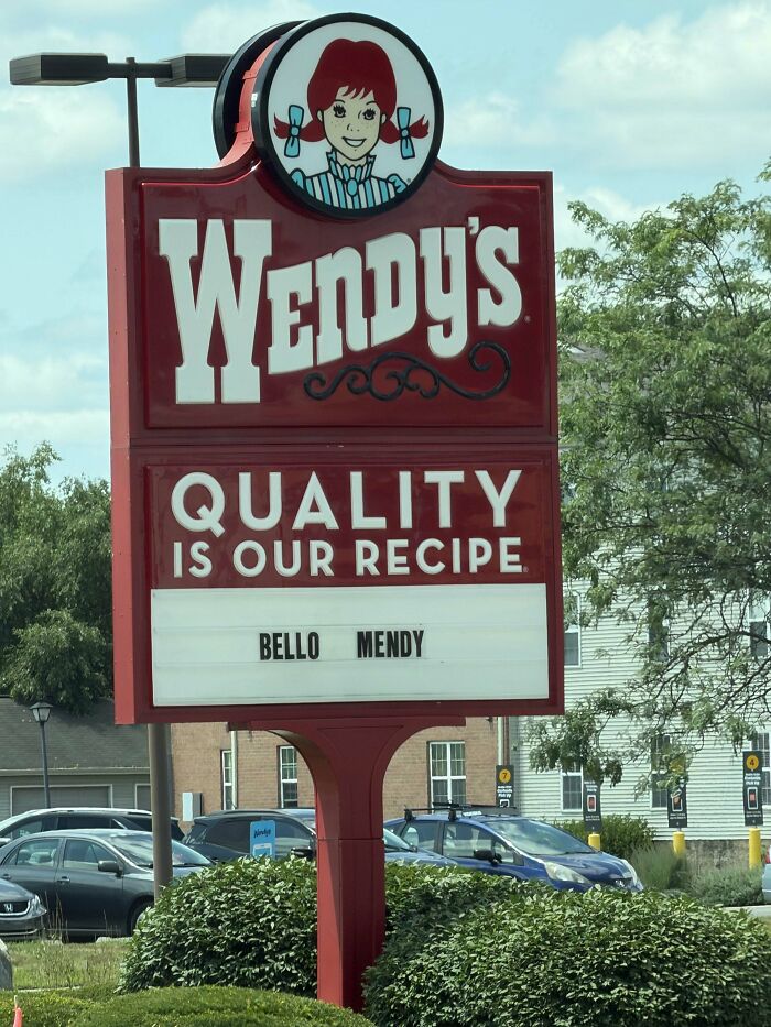 A Wendy's sign with a message that reads Quality is our recipe and Hello Mendy, a quirky sign from the universe.
