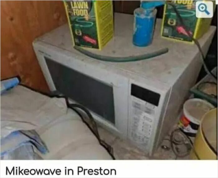 A dirty, old microwave in Preston with lawn food boxes on top, demonstrating the weirdest people on an online marketplace.