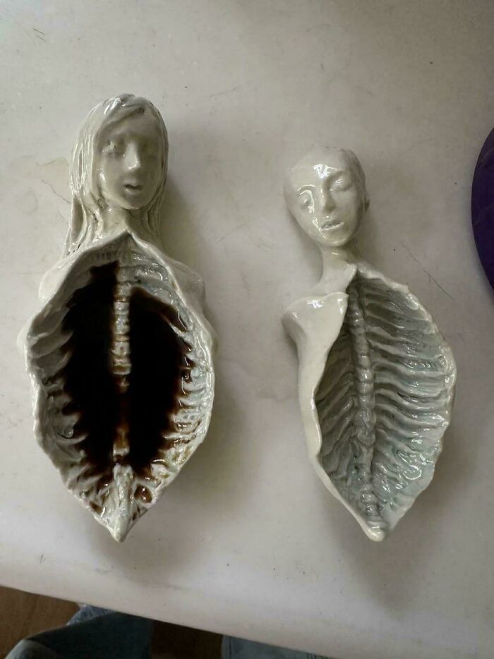 Two ceramic sculptures of torsos with exposed rib cages, disturbing levels of skill.