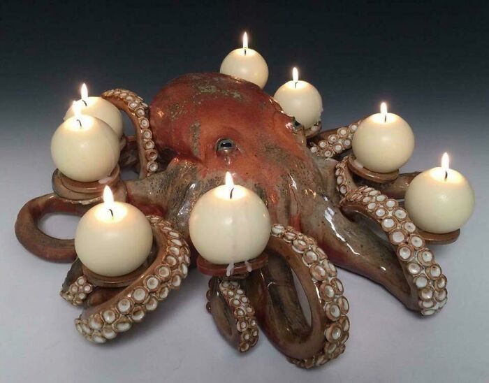 Unique octopus-shaped candelabra with lit candles, an example of amazing crafts and creativity.