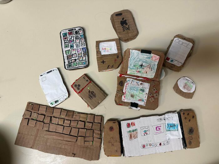 Collection of cardboard crafts shaped like phones, game consoles, and a keyboard, showing amazing crafts.