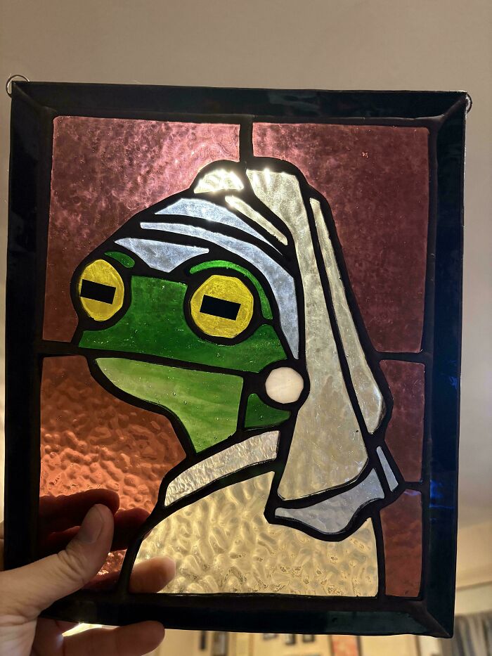 A stained glass craft art piece featuring a frog dressed as the Girl with a Pearl Earring, showcasing amazing crafts.