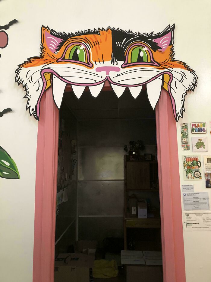 A vibrant, cartoonish cat face crafted above a doorway, displaying amazing crafts.