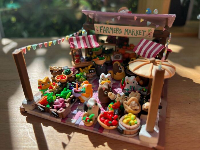 A miniature Farmers Market diorama with tiny produce and figures, showcasing amazing crafts.