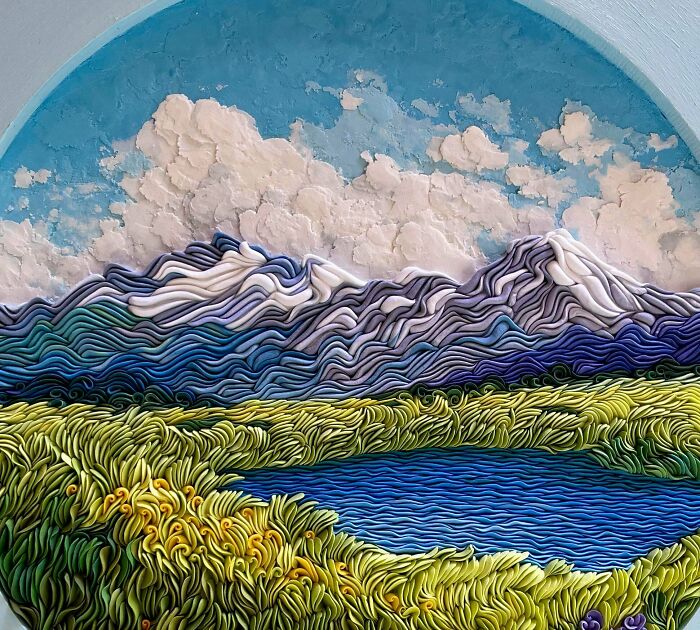 Amazing crafts showing a textured landscape with mountains, a lake, and grass.