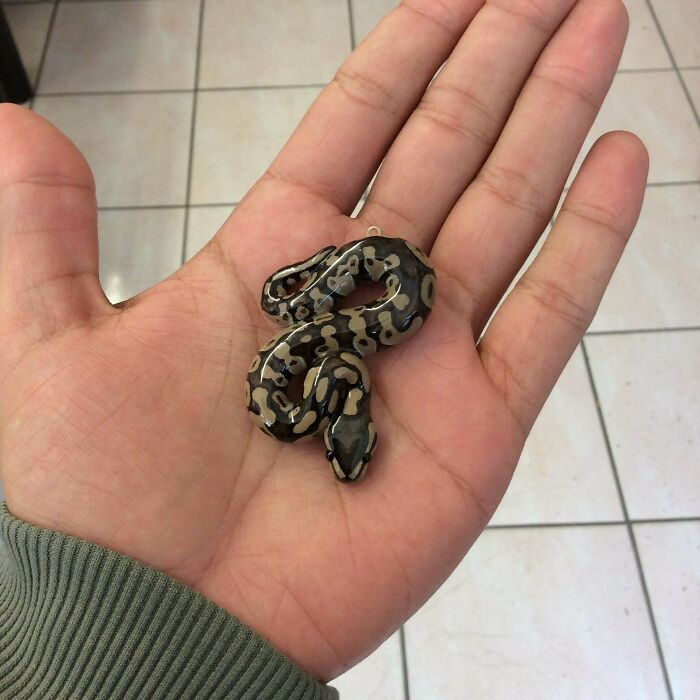 Amazing crafts: Detailed snake figurine held in a hand, showcasing people's ability to go above and beyond in crafting.