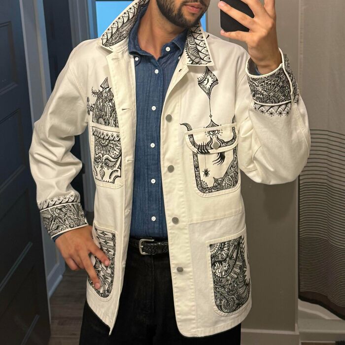 Amazing crafts: Man wearing a custom-designed jacket with intricate patterns, highlighting people's ability to go above and beyond.