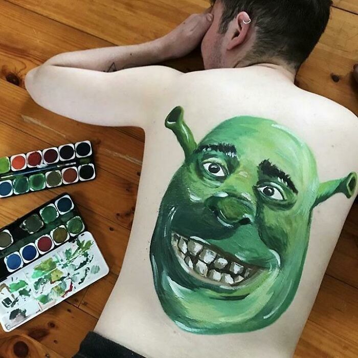 Amazing crafts: A person's back painted with a detailed Shrek face, showcasing incredible artistic talent and creativity.
