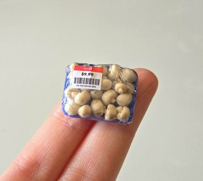 Amazing crafts: A tiny, miniature package of mushrooms held between fingers, showcasing intricate detail in small-scale crafts.