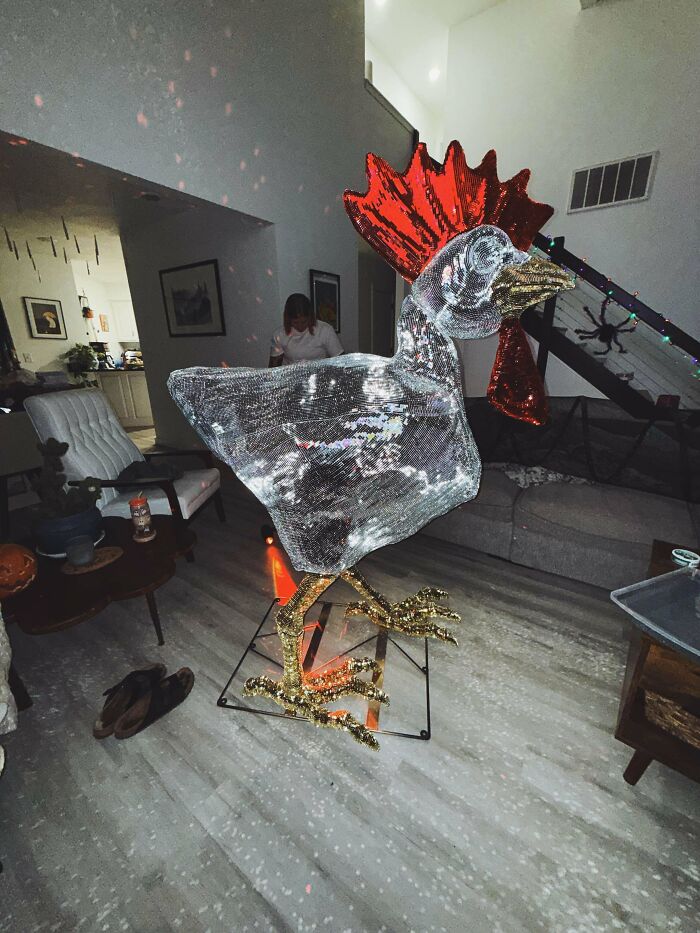 A large, sparkling rooster craft made from reflective materials, a testament to amazing crafts.