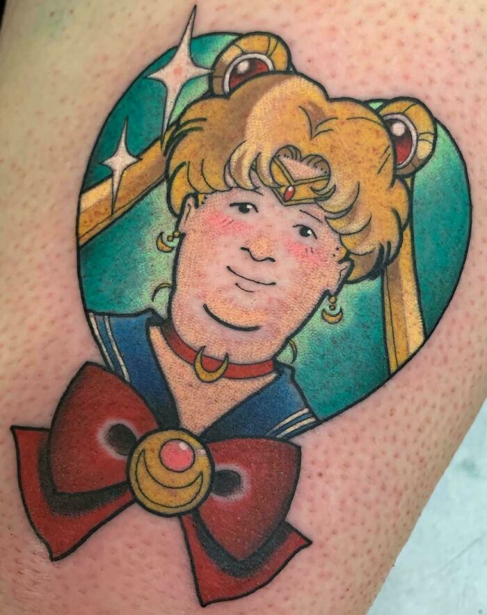A tattoo of Sailor Moon with the face of King of the Hill character, an awful idea executed with skill.