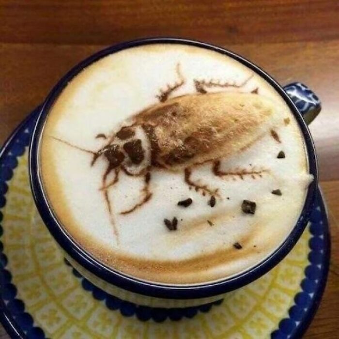 Coffee latte art depicting a large cockroach in a cup, an awful idea with disturbing levels of skill.