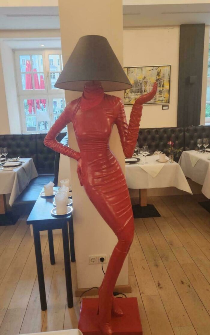 A lamp made to look like a red-clad woman, an awful idea executed with disturbing skill.