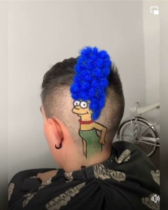 A person with a Marge Simpson haircut, featuring a vibrant blue beehive and painted cartoon face, a disturbing level of skill.