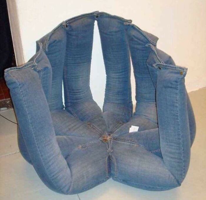 A chair made entirely of blue jeans, showcasing awful ideas executed with disturbing skill.