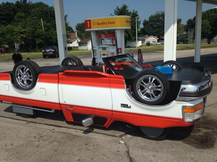 A car flipped upside down on another car, an awful idea executed with disturbing levels of skill.