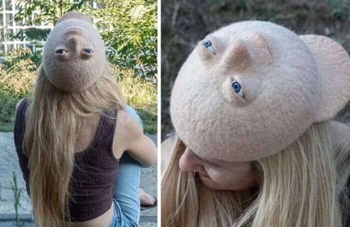 Woman wearing a hat that looks like an upside-down face, an awful idea with disturbing levels of skill.