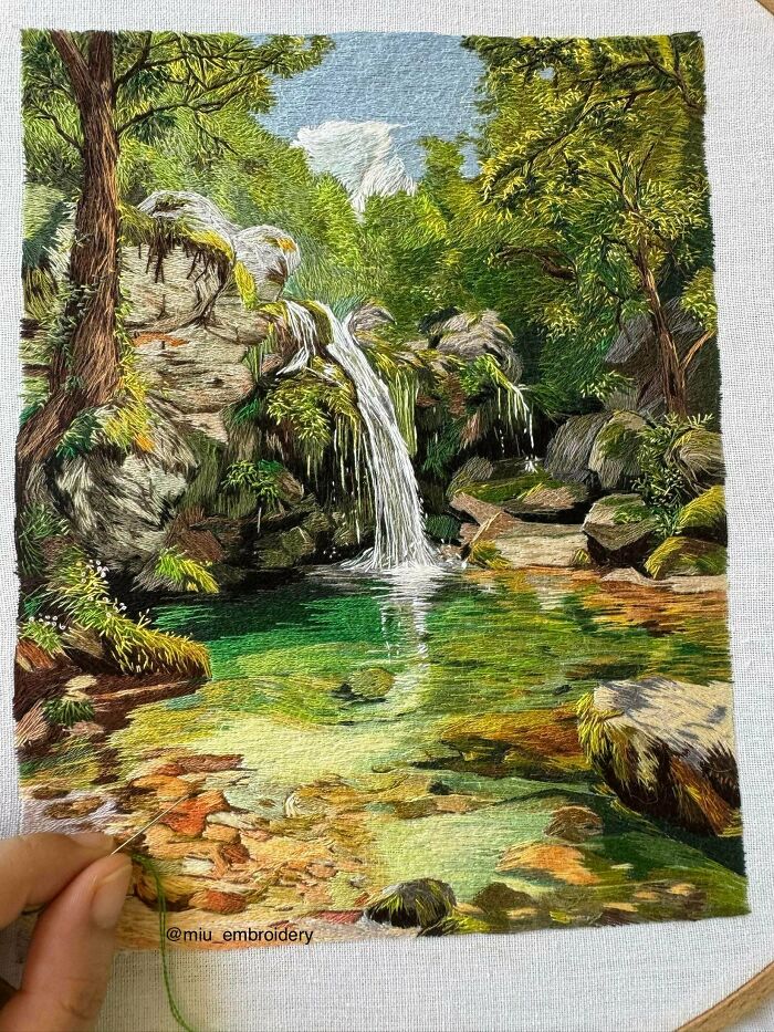 Beautiful embroidery projects depicting a lush green forest with a flowing waterfall and clear pool