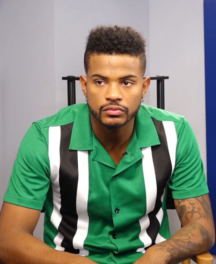 Trevor Jackson looking at the camera wearing a green collared shirt with black and white stripes. This image highlights Trevor Jackson's career.