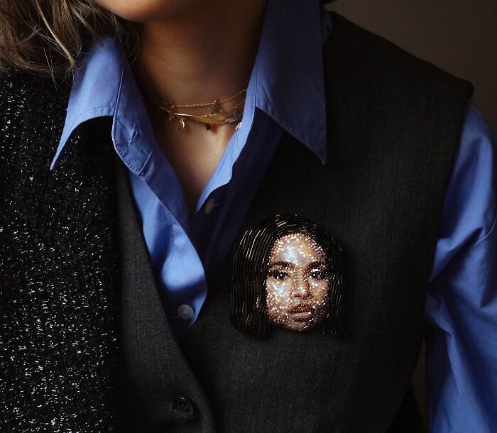 Tiffany Pisani beaded creations: Portrait brooch on a dark vest and blue shirt.