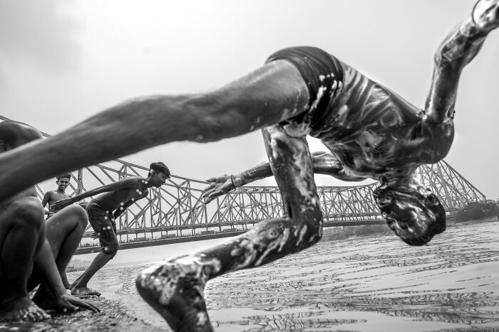 A person diving into water in a black and white street photo, capturing life's coincidences.