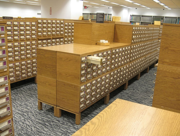Rows of wooden card catalogs fill a large room, a familiar school experience that kids today will never see.