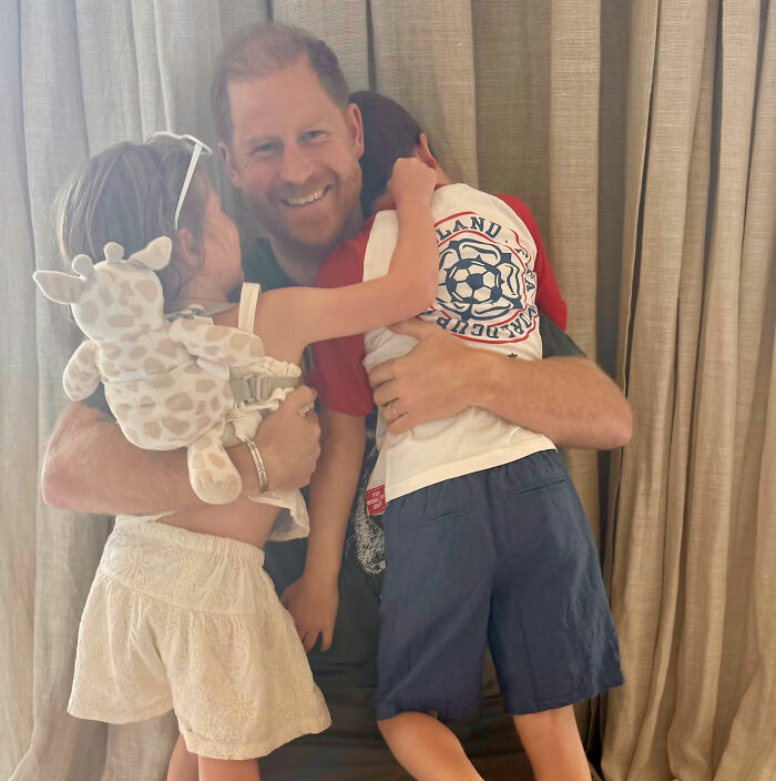Prince Harry smiling while hugging his kids, renewing concern for Meghan Markle's kids. Prince Harry smiling while hugging his kids, renewing concern for Meghan Markle's kids.