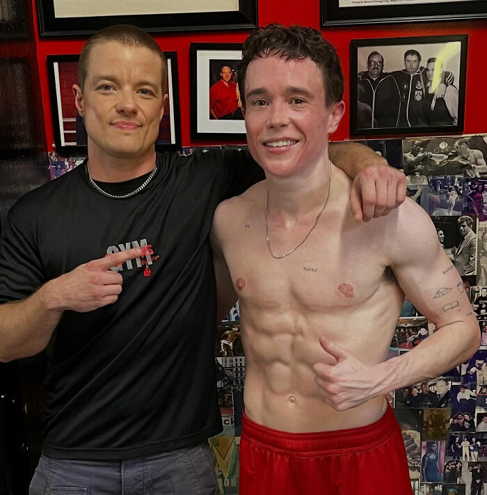 Elliot Page shirtless, flexing with a trainer in a gym, amidst images, sparking discussions on trans people.