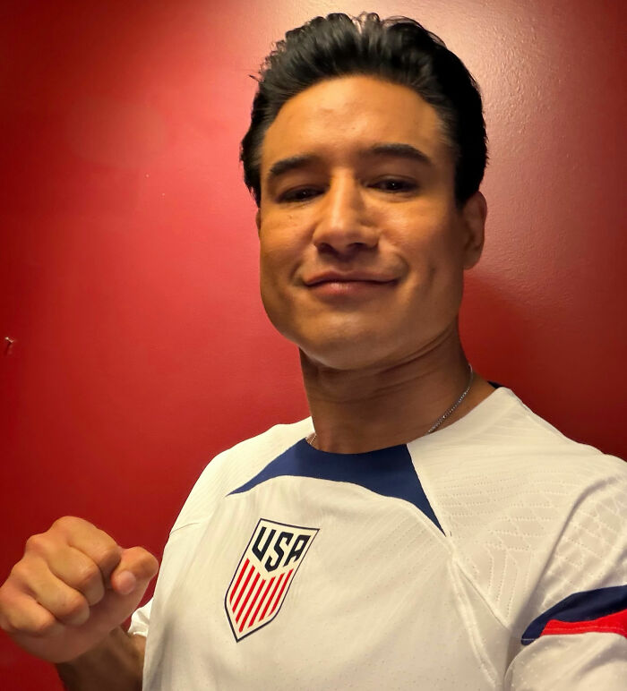 Mario Lopez in a USA soccer jersey, smiling, sparking controversy.