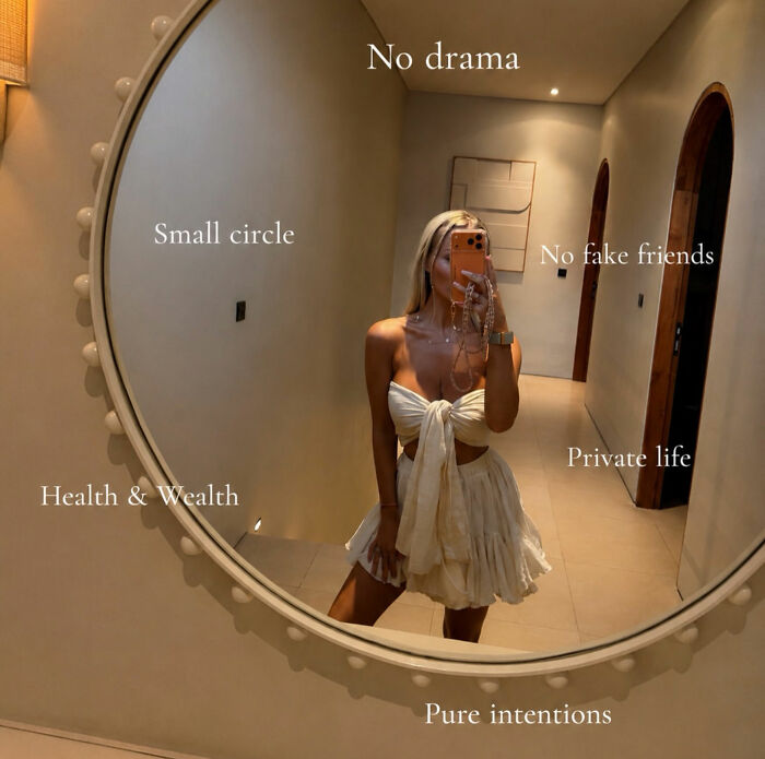 Young woman taking a mirror selfie, with text overlaying the reflection, describing her nightmare Bali experience.