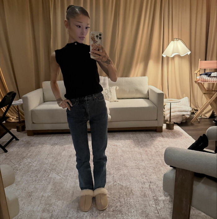 Ariana Grande in a casual pose, looking into a mirror, after an appearance in music video stunned fans. Ariana Grande in a casual pose, looking into a mirror, after an appearance in music video stunned fans.
