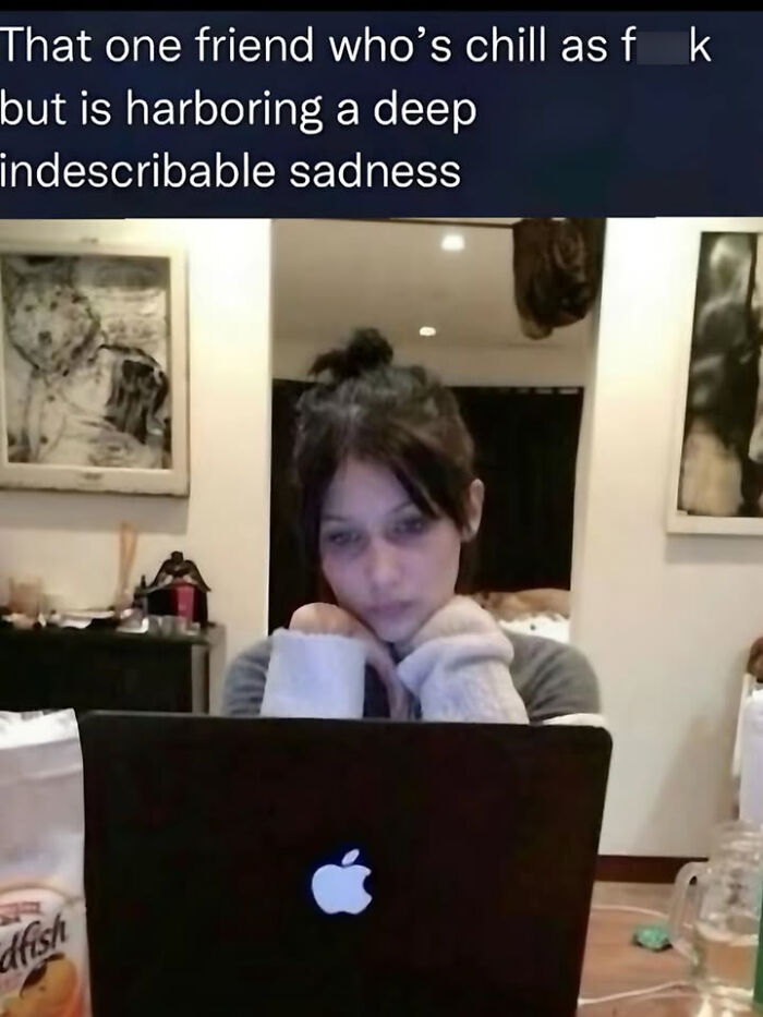 A funny meme showing a woman looking intently at a laptop, representing a chill friend with hidden sadness.