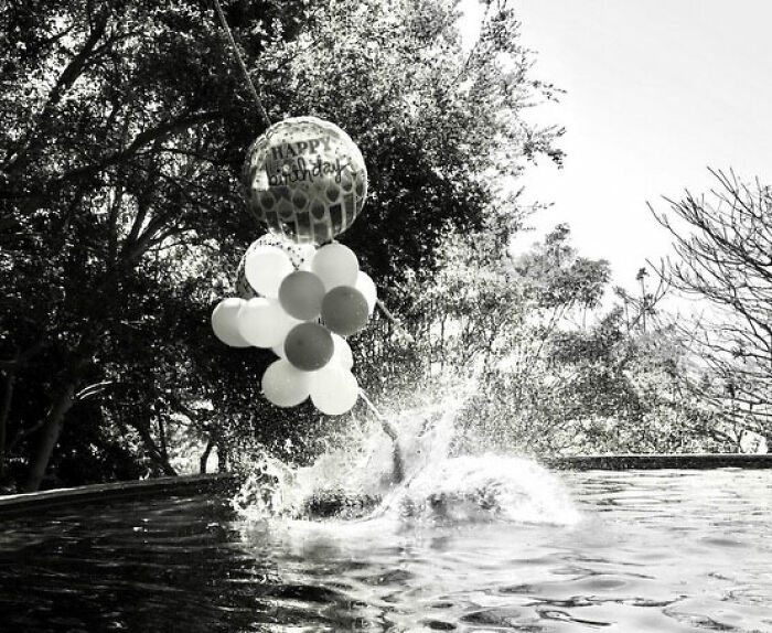 Birthday balloons float above a pool as someone makes a splash, details from Meghan Markle's post. Birthday balloons float above a pool as someone makes a splash, details from Meghan Markle's post.