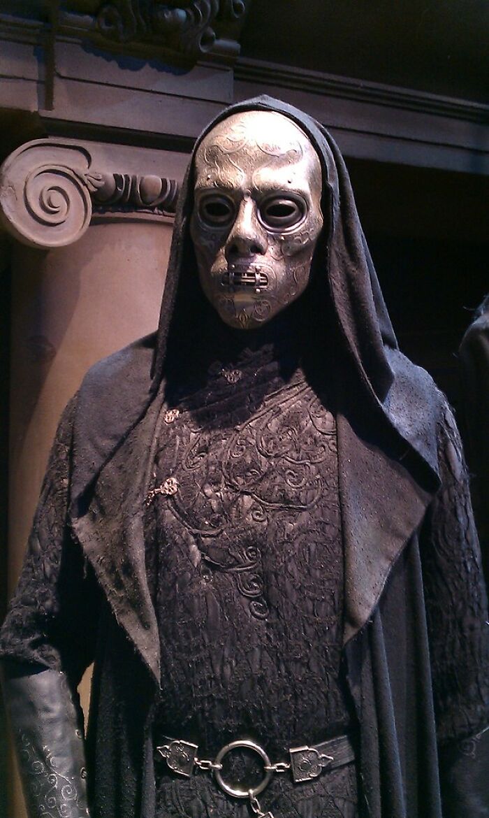 A figure in a dark hooded cloak and a skull-like mask, representing creepy true stories and questioning reality.