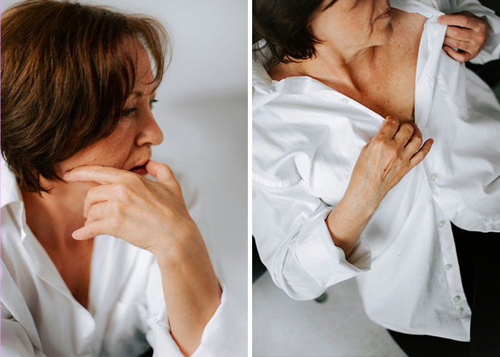Woman looking concerned while unbuttoning her shirt, possibly due to perimenopause symptoms.