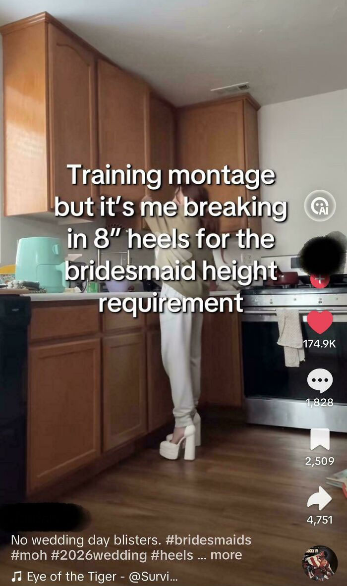 A woman in a kitchen practicing walking in high heels to meet a wedding day height requirement.