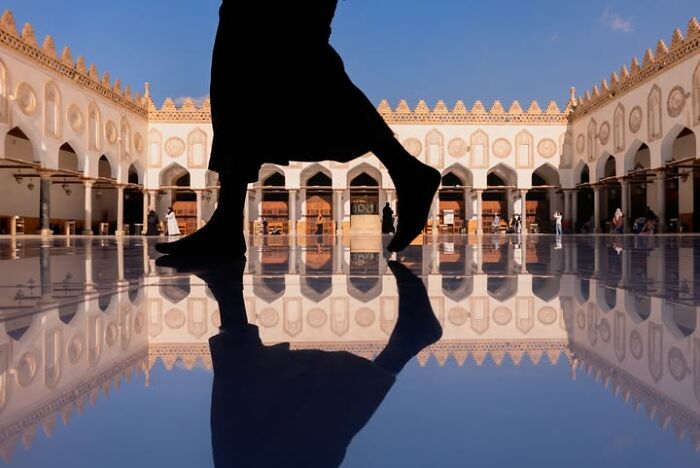 Murat Bakmaz captures the easily missed beauty of everyday life: A person's silhouette walks across a reflective floor in an ornate building.