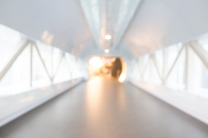 A blurred long hallway with bright light at the end, metaphorically depicting the line between life and what comes after.