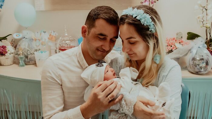 A smiling couple lovingly holding a newborn baby, in context with controlling what a boyfriend eats.