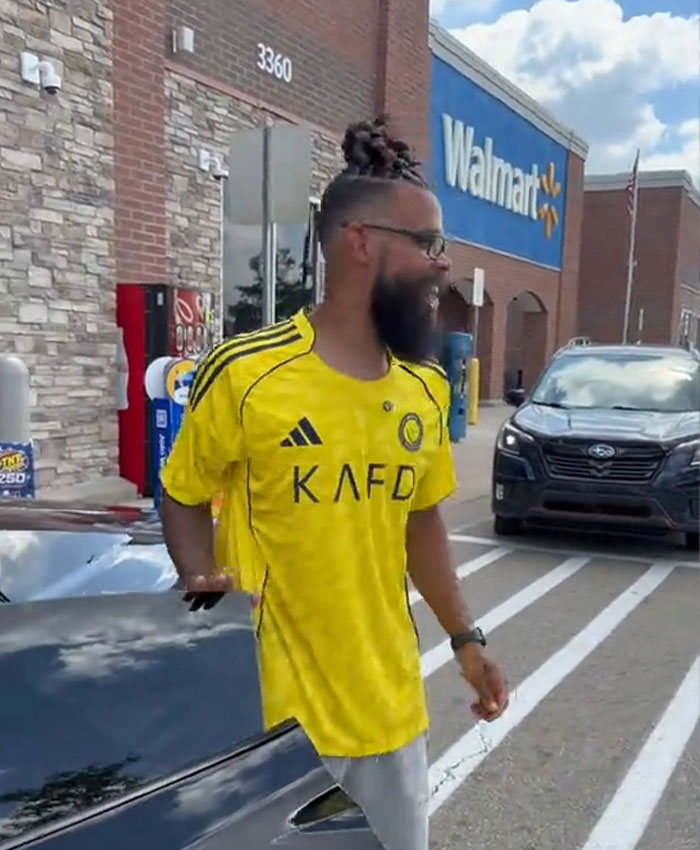 Influencer walking out of Walmart, potentially after being banned for his grocery shopping activities and behavior.