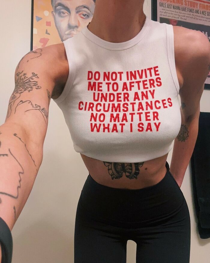 A person wearing an iconic shirt that says DO NOT INVITE ME TO AFTERS UNDER ANY CIRCUMSTANCES NO MATTER WHAT I SAY.