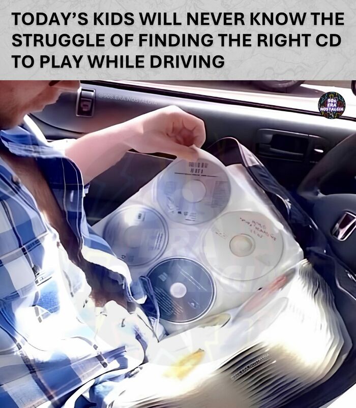Man looking through a CD binder in a car, a humorous '90s meme about finding the right music while driving.