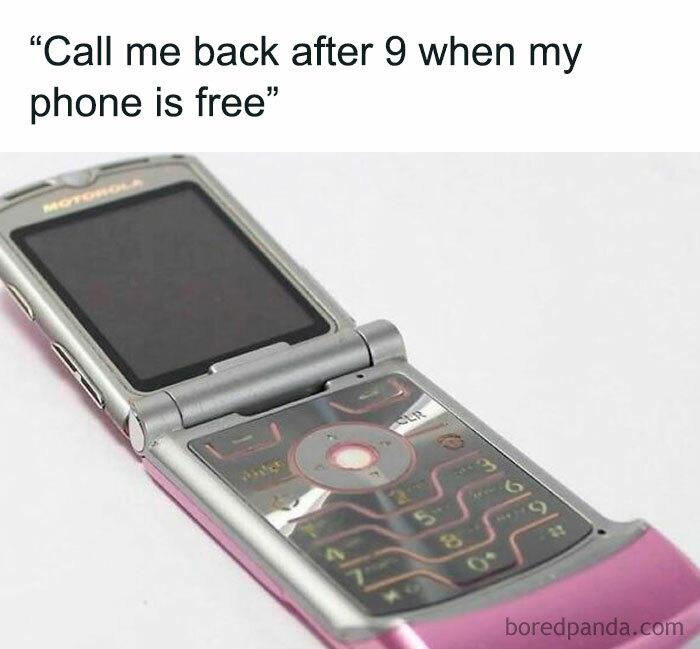 A close-up of a pink Motorola flip phone, a nostalgic 90s meme representing phone use.