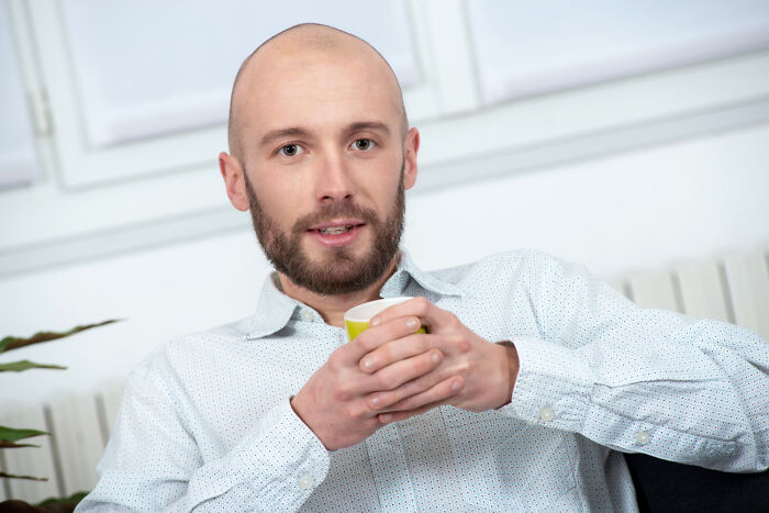 A man holding a cup, possibly reflecting on shocking employee stories and their consequences.
