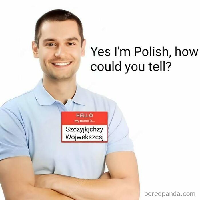 A man with a name tag showing a complex Polish name, humorously depicting Eastern European identity.