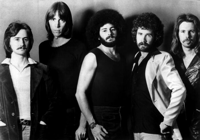 Black and white photo of a band, representing the public's fascination with dating a celebrity.
