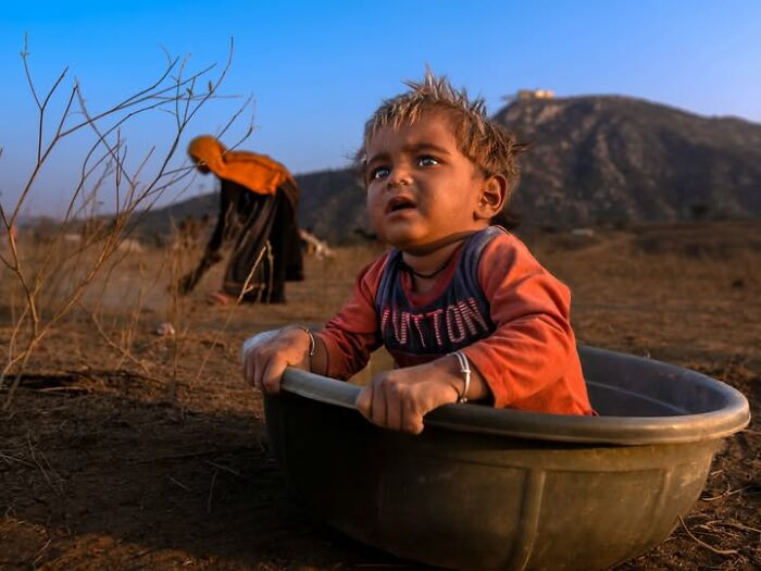 Remarkable photograph by Tittu Shaji Thomas of a child in a tub, capturing life across cultures and landscapes.